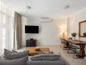 a living room with a couch and a table at The Sebel Byron Bay in Byron Bay
