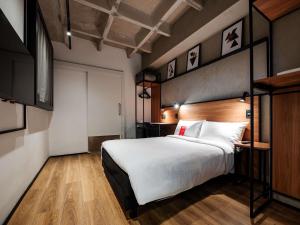 a bedroom with a large white bed and wooden floors at ibis Pelotas - Recem inaugurado in Pelotas +122 photos