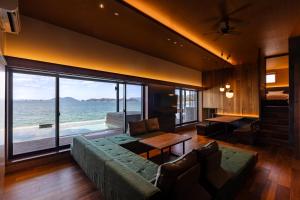 a living room with a couch and a view of the ocean at Sunset SPA Resort AJI by SETO CLAS in Takamatsu