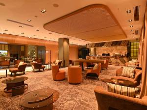 a lobby with couches and chairs in a hotel at Mercure Tashkent North in Tashkent