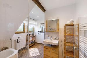a bathroom with a sink and a mirror at Fewo Sonnenstübchen Mendig 2Pers in Mendig +22 photos