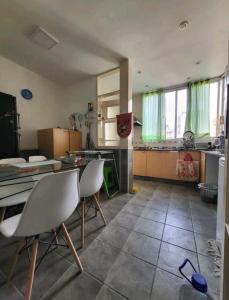 a kitchen with a table and chairs in a room at Habitacion de congreso in Buenos Aires