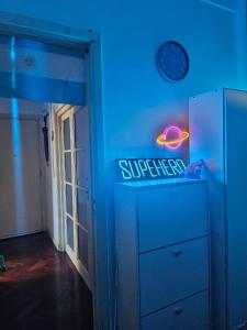 a blue room with a dresser and a blue light at Habitacion de congreso in Buenos Aires