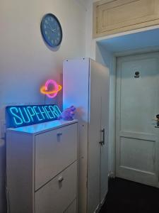 a clock on a wall next to a refrigerator at Habitacion de congreso in Buenos Aires