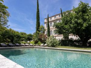 a swimming pool in front of a building at Château de Mazan - Handwritten Collection in Mazan