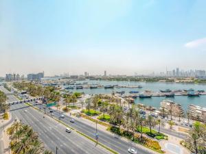 a view of a city with a river and buildings at Mövenpick Dubai Creek in Dubai