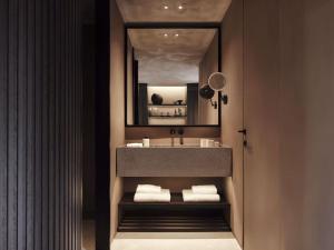 a bathroom with a sink and a mirror at Nirema Hotel & Spa Samos - MGallery Collection in Samos +32 photos