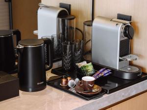 a kitchen counter with a coffeemaker and coffee makers at MOVENPICK TASHKENT OLD CITY in Tashkent