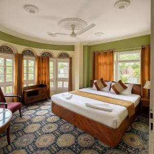 a bedroom with a large bed in a room at Heritage Rose Inn in Srinagar