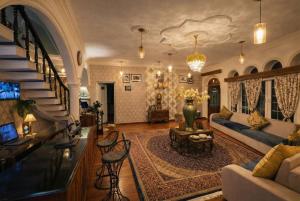 a living room with a couch and a table at Heritage Rose Inn in Srinagar