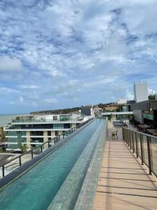 a swimming pool on the roof of a building at Flat FM20 Apt 401 in João Pessoa