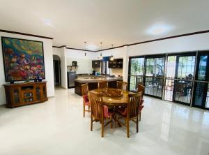 a kitchen and dining room with a table and chairs at Tha sala beach house in Ban Phang Pling