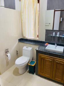 a bathroom with a toilet and a sink at Tha sala beach house in Ban Phang Pling +8 photos