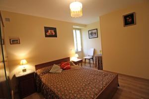 a bedroom with a bed and a table and a chair at La bachellerie in Nedde