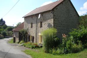 a brick house with a yellow door on a street at La bachellerie in Nedde