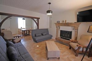 a living room with a couch and a fireplace at Naugeat in La Roudie