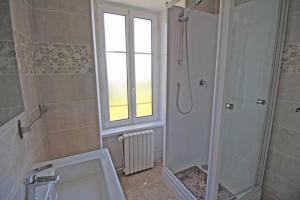 a bathroom with a shower and a toilet and a sink at Naugeat in La Roudie +12 photos