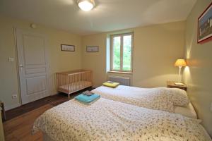 a bedroom with a bed with two books on it at Le petit feuillade in Saint-Laurent-sur-Gorre