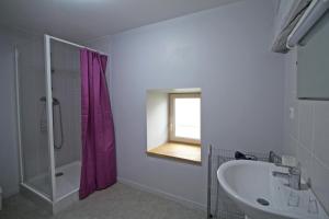 a bathroom with a tub and a sink and a window at Le petit feuillade in Saint-Laurent-sur-Gorre +12 photos