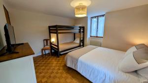 a bedroom with a bed and a bunk bed at La grande ourse in Panazol