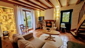 a living room with a couch and a fireplace at La grande ourse in Panazol