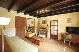 a living room with a bed and a television at Pierre-brune in Saint-Priest-Taurion