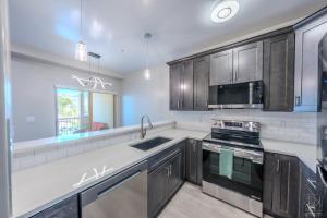 a kitchen with a sink and a stove at Historic Main Street Hotel in Pleasant Grove