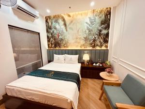 a small room with a bed and a couch at Cera Hotel in Ho Chi Minh City