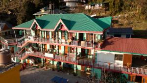 an aerial view of a building with a green roof at DreamCatcher & Homestay in McLeod Ganj