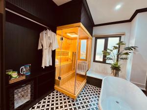 a bathroom with a shower and a white tub at Cera Hotel in Ho Chi Minh City
