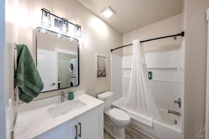 a bathroom with a sink and a toilet and a mirror at Historic Main Street Hotel in Pleasant Grove +39 photos