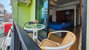 a balcony with a table and a bed on a balcony at Smyrna in Pattaya