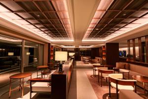 a restaurant with tables and chairs in a building at RAV RESORT Okinawa in Yomitan