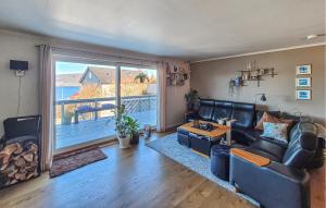 a living room with a couch and a large window at Nice Home In Ask With Wifi in Ask i Nordhordaland