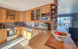 a kitchen with a bowl of fruit on a table at Nice Home In Ask With Wifi in Ask i Nordhordaland