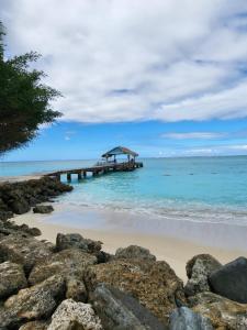 a pier in the ocean next to the beach at Crown Point Condos by Nasin in Crown Point +3 photos