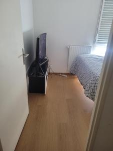 a bedroom with a bed and a tv in a room at Repos chez l habitant in Rennes