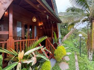 a porch of a house with plants on it at Casa Vella Cottages by AGATA in Bedugul