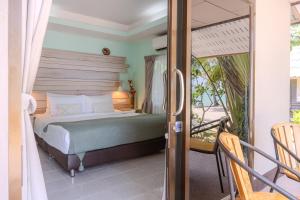 a bedroom with a bed and a balcony at Phangan Beach Resort in Ban Tai +56 photos
