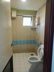 a bathroom with a toilet and a window at Hotel Wings Kuala Lumpur in Kuala Lumpur