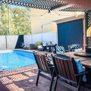 a patio with a table and chairs next to a pool at Dalby Parkview Motel in Dalby