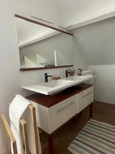 a bathroom with a white sink and a mirror at Villa Mayeux in Giverny +82 photos