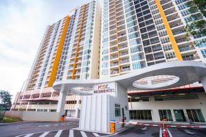a large tall building with a sign in front of it at Residences at Daya near Mount Austin by SR Home in Johor Bahru