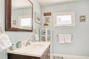 a white bathroom with a sink and a mirror at Sunshine House in Ventnor City +53 photos
