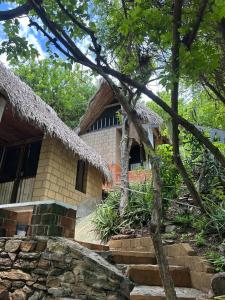 a house with a stone staircase in front of it at Las lemurias in Mazunte