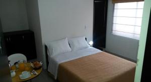 Postel nebo postele na pokoji v ubytování A Bogota On Holidays by Open - HOTEL CAS-EMBAJADA AMERICANA
