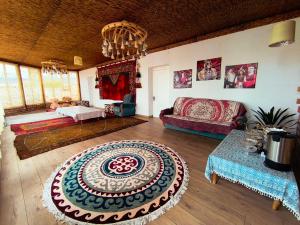 a living room with a couch and a large rug at Nukura in Bokonbayevo