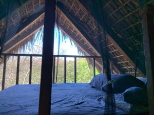 a bed in a tent with a window at Las lemurias in Mazunte +16 photos