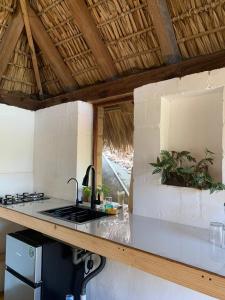 a kitchen with a stove and a counter top at Las lemurias in Mazunte