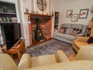 a living room with a couch and a fireplace at Riverlea in Rhyl